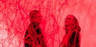 Members enjoying a private viewing of Chiharu Shiota’s Uncertain Journey 2016/2022 in ‘The Soul Trembles’, Gallery of Modern Art / Metal frame, red wool / © Chiharu Shiota