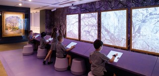 Students participate in Gary Carsley’s interactive project ‘Purple Reign’, inspired by R Godfrey Rivers’s Under the Jacaranda 1903 (far left), during APT9 Kids, October 2018 / Photograph: Chloë Callistemon
